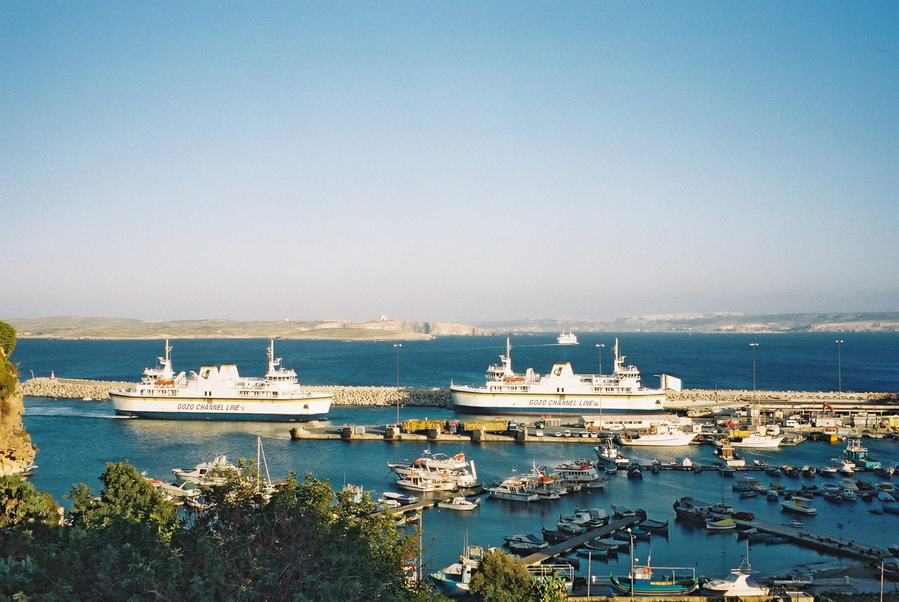 Mġarr Harbour on Gozo, with ferry ships and the islands beyond.