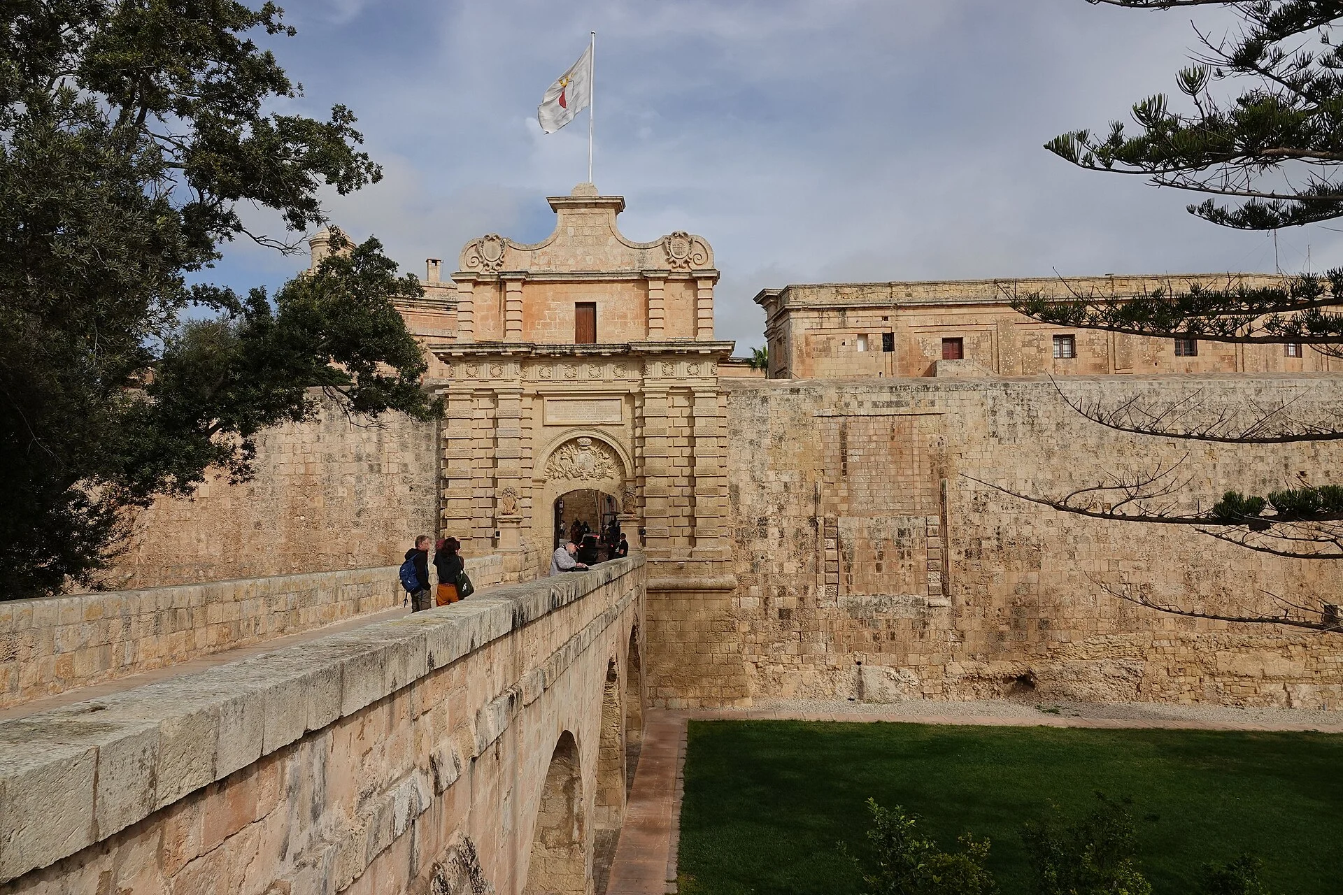 Visitors crossing the bridge at Mdina’s Main Gate in Malta.
